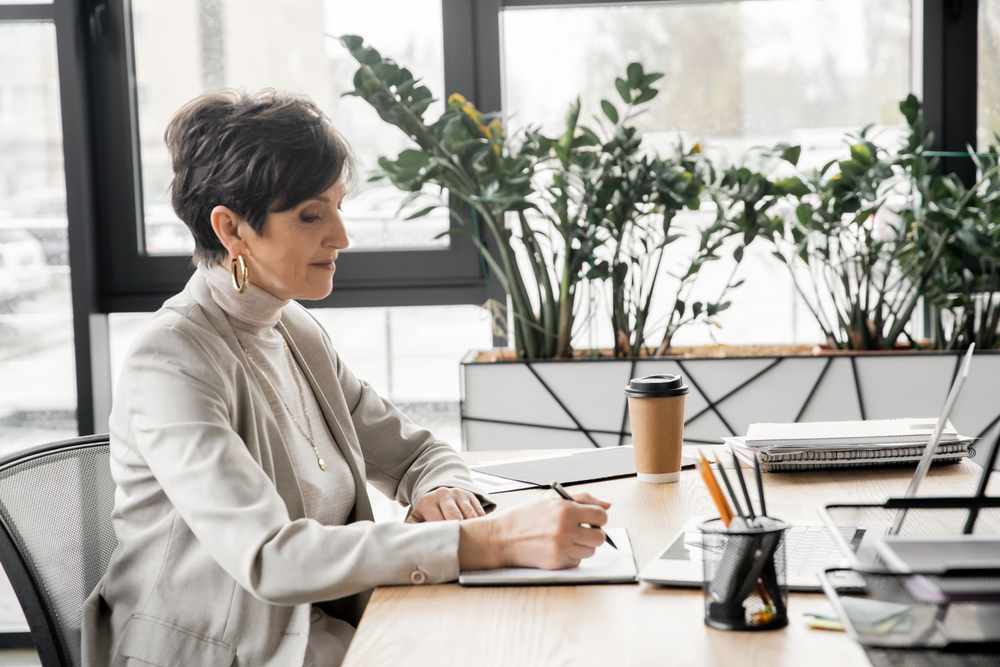 Business leader writing notes on business growth